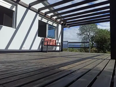 a deck with a chair on top of a house at Terrazas de Yacanto in Villa Yacanto