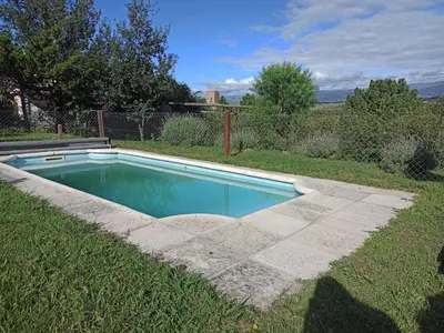 a swimming pool in the middle of a yard at Terrazas de Yacanto in Villa Yacanto