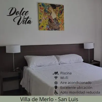 a bedroom with a bed with a painting on the wall at Dolce Vita in Merlo
