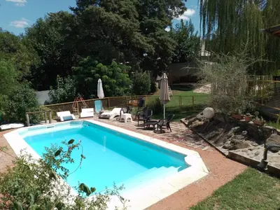 a swimming pool in the backyard of a house at Cabañas Cangas de Onis MAYU SUMAJ in Villa Icho Cruz