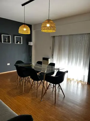 a dining room with a glass table and chairs at El Abrojal 3 - Dpto 1 dormitorio a 3 cuadras Patio Olmos in Cordoba