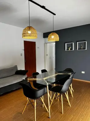 a dining room with a glass table and chairs at El Abrojal 3 - Dpto 1 dormitorio a 3 cuadras Patio Olmos in Cordoba