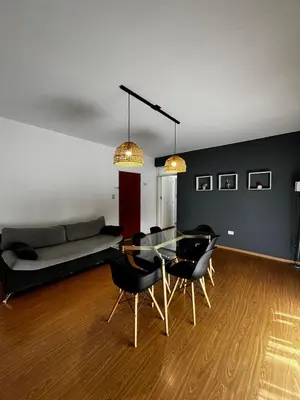 a living room with a glass table and black chairs at El Abrojal 3 - Dpto 1 dormitorio a 3 cuadras Patio Olmos in Cordoba