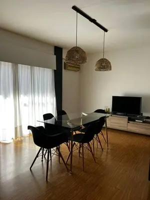 a dining room with a glass table and chairs at El Abrojal 3 - Dpto 1 dormitorio a 3 cuadras Patio Olmos in Cordoba