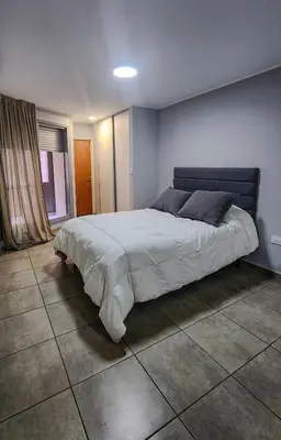 a bedroom with a large bed in a room at Loft General Paz in Cordoba