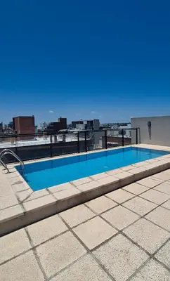 a swimming pool on the roof of a building at Loft General Paz in Cordoba
