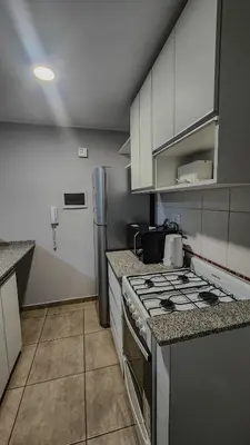a kitchen with a stove and a refrigerator at Loft General Paz in Cordoba
