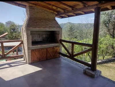 a patio with an outdoor oven on a deck at Cabaña de piedra Los Crespines in San Antonio de Arredondo