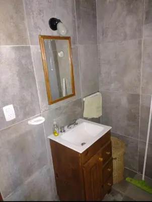 a bathroom with a sink and a mirror at Cabaña de piedra Los Crespines in San Antonio de Arredondo