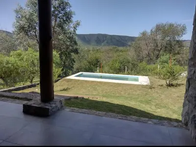 a view of a swimming pool from the balcony of a house at Cabaña de piedra Los Crespines in San Antonio de Arredondo