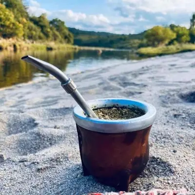 a cup of dirt with a knife in it on a beach at Jasy Cabañas in Potrero de Garay