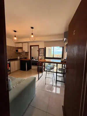 a kitchen and living room with a table and chairs at Buena Vista in Alta Gracia