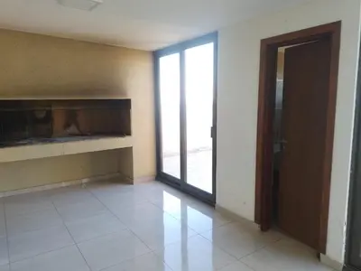 an empty room with a fireplace and a door at Buena Vista in Alta Gracia