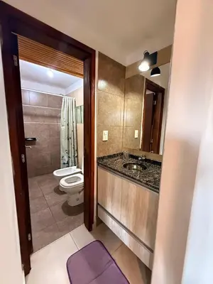 a bathroom with a toilet and a sink and a mirror at Buena Vista in Alta Gracia