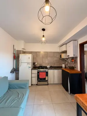 a kitchen with a refrigerator and a stove top oven at Buena Vista in Alta Gracia