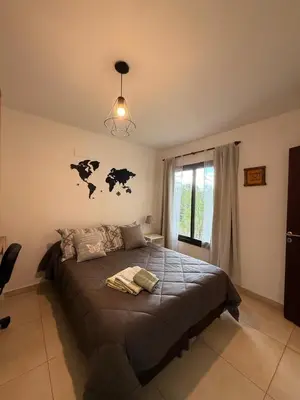 a bedroom with a bed with a map on the wall at Buena Vista in Alta Gracia