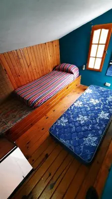 a room with a bed and a window in a cabin at Ofelia, departamento en Alta Gracia. in Alta Gracia