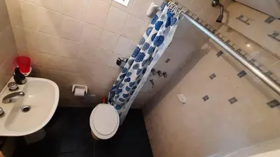 a bathroom with a toilet and a sink and a shower at Ofelia, departamento en Alta Gracia. in Alta Gracia