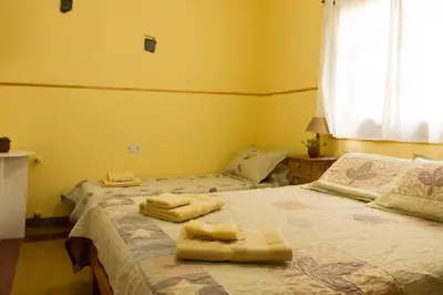 two beds in a room with towels on them at HOSTERÍA ARROYO CRISTAL in Cavalango