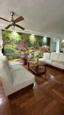 a living room with white couches and a painting on the wall at Hotel Bristol in Cordoba