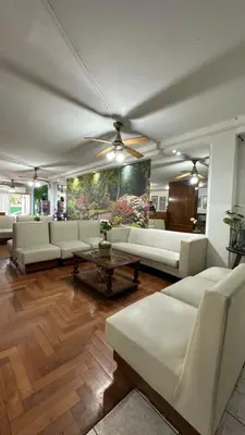 a large living room with white couches and a table at Hotel Bristol in Cordoba