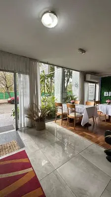 a large living room with a table and chairs at Hotel Bristol in Cordoba