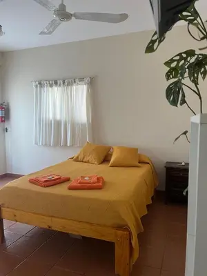 a bedroom with a bed with two towels on it at Casa Lavanda in Embalse
