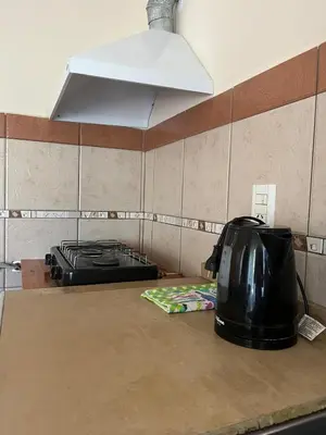 a black toaster sitting on a counter in a kitchen at Casa Lavanda in Embalse