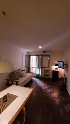 a living room with a couch and a table at Estancia Nueva Córdoba II in Cordoba
