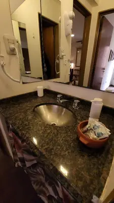 a bathroom counter with a sink and a mirror at Estancia Nueva Córdoba II in Cordoba