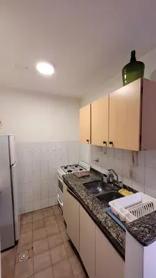 a kitchen with a sink and a stove top oven at Estancia Nueva Córdoba II in Cordoba
