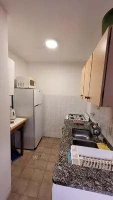 a kitchen with a counter top and a refrigerator at Estancia Nueva Córdoba II in Cordoba