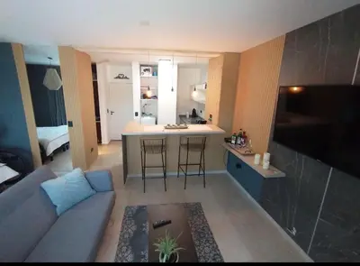 a living room with a couch and a kitchen at Depto VCP in Villa Carlos Paz