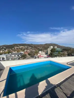 a swimming pool on the roof of a house at Depto VCP in Villa Carlos Paz