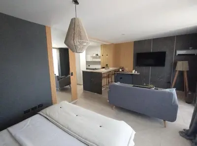 a room with a bed and a kitchen with a tub at Depto VCP in Villa Carlos Paz