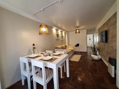 a white table and chairs in a living room at Excelente Depto - Patio Olmos in Cordoba