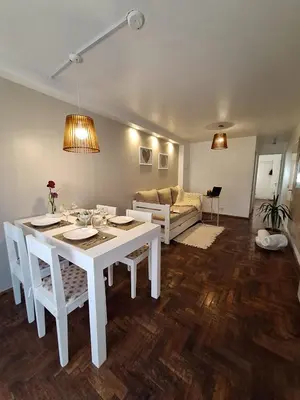 a white table and chairs in a living room at Excelente Depto - Patio Olmos in Cordoba