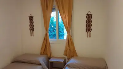 a room with two beds and a window at Departamento Céntrico in Villa Carlos Paz