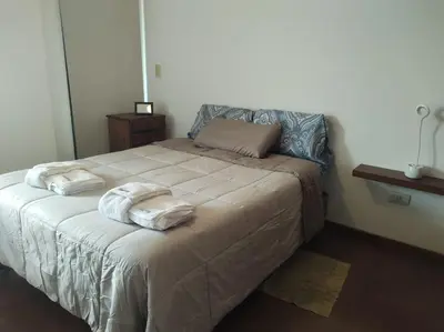 a bedroom with a bed with towels on it at Departamento Centrico con terraza propia in Río Cuarto