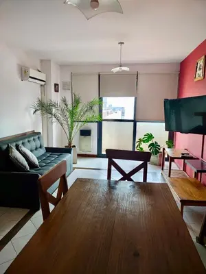 a living room with a couch and a table at Departamento Centrico con terraza propia in Río Cuarto
