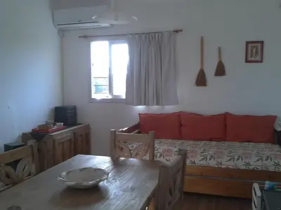a living room with a bed and a table with a dining table sidx sidx sidx at Estancia de Campo in Estancia Vieja