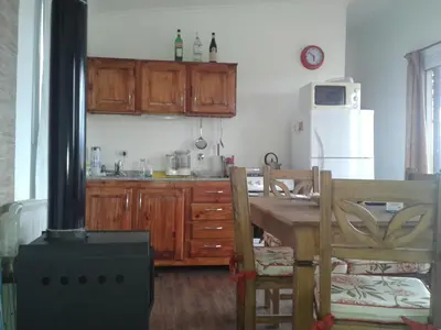 a kitchen with a stove and a table and a kitchen with a stove at Estancia de Campo in Estancia Vieja