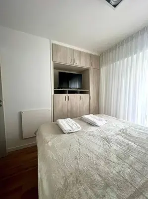 a bedroom with a bed with two towels on it at Departamento cálido y tranquilo SS2 in Cordoba
