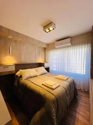 a bedroom with a bed with two towels on it at Departamento en hermosa zona de Nueva Córdoba. SS3 in Cordoba