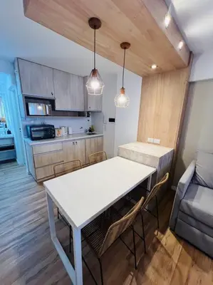 a kitchen with a table and chairs in a room at Departamento en hermosa zona de Nueva Córdoba. SS3 in Cordoba
