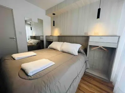 a bedroom with a bed with two pillows on it at Estudio - apartamento renovado y confortable SS4 in Cordoba