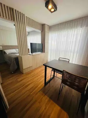 a room with a table and a bed and a television at Estudio - apartamento renovado y confortable SS4 in Cordoba