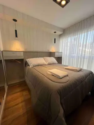 a bedroom with a large bed with two pillows on it at Estudio - apartamento renovado y confortable SS4 in Cordoba