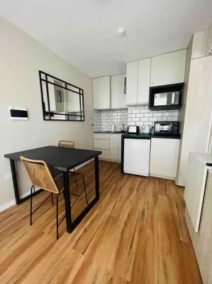 a room with a black table and a kitchen at Estudio - apartamento renovado y confortable SS4 in Cordoba