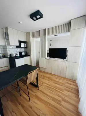 a living room with a table and a kitchen at Estudio - apartamento renovado y confortable SS4 in Cordoba